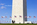 Patriotc American family passing into view with the bottom section of the Washington Monument encircled by American flagpoles