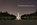 Night photograph from the western-side of the Reflecting Pool looking back along Elm Walks towards the illuminated Washington Monument, DC