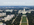 Grand aerial view of the ceremonial tree-lined boulevard of the Mall in Washington DC flanked with Smithsonian museums & the United States Capitol Building in the distance