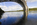 Artistic vista of the iconic steel arch/ curve of Britannia Bridge reflecting off the surface of the Menai Strait