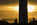 Daybreak view of the bottom-half of America's national monument, the Washington Monument including American flagpoles and Capitol Dome in the distance, Washington DC