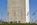 The bottom section and base of the Washington Monument, featuring American flagpoles and tourists, The Mall, Washington DC