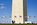 Washington Monument scene featuring the base, plaza, American fagpoles and tourist crowds around the national monument of America, Washington DC