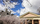 Spring scene featuring the outdoor signage and pediment of the Greek Revival styled Athenaeum building including cherry blossoms in peak bloom, Alexandria, Virginia