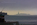 A moody East River scene featuring a view of Liberty Island and the Statue of Liberty partially obscured by dense fog, New York City