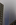 A moody Lower Manhattan street level scene featuring a section of the One World Trade Center partially obscured by dense fog, Manhattan, New York City