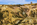 The view of the opencast copper mine at Parys Mountain, featuring the remains of the Grade II Listed windmill in the distance, Amlwch, Anglesey, Gwynedd