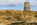 Unique scene from the opencast copper mine at Parys Mountain featuring the remains of the Grade II Listed windmill at the summit including the copper mine trail footbridge, Amlwch, Anglesey, Gwynedd