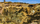 Unique summer scene from the opencast copper mine at Parys Mountain, featuring the remains of the historic windmill and copper mine trail footbridge in the distance, Amlwch, Isle of Anglesey, Gwynedd