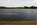 A distant view of the Jacobean styled Kensington Palace from the far-end of Round Pond, Kensington Gardens, London