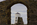 Unique scene from Llanddwyn Island featuring a view of Twr Mawr Lighthouse through the window of the ruins of Llanddwyn Chapel, Newborough National Nature Reserve, Isle of Anglesey, Gwynedd
