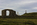 Llanddwyn Island scene featuring the ruins of Llanddwyn Chapel, Twr Mawr Lighthouse and the cross of St Dwynwen, Area of Outstanding Natural Beauty, Anglesey, Gwynedd