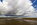 A beautiful Red Wharf Bay beachscape, seascape and cloudscape reflection featuring fluffy cumulus clouds and coastline in the distance, Isle of Anglesey, Gwynedd
