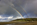 A unique beachscape scene from Red Wharf Bay featuring a double rainbow and the headland at Llanddona, Area of Outstanding Natural Beauty, Anglesey, North Wales