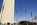 Unique early spring view from the base of America's national monument, featuring the American flagpoles, tourist crowds and elliptical plaza, Washington Monument, Washington DC