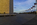Washington Monument circular paved plaza view at dusk featuring the United States Capitol in the distance and American flagpoles circling the base of the national memorial, National Mall, Washington DC