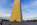 Sundown scene from the main paved plaza of the Washington Monument featuring a view of the United States Capitol in the distance and the bottom section of the national obelisk glowing in the fading light, National Mall, Washington DC