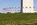 View from the mound or the knoll surrounding the national monument including the fifty American flagpoles circling the paved plaza, The Mall, Washington DC