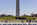 Distant view of the base of the Washington Monument encircled by fifty American flagpoles from the National World War Two Memorial, Washington DC