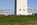Patriotic scene featuring fifty American flagpoles encircling the base and plaza of the Washington Monument, Washington DC