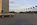 Dayset scene from the circular paved plaza of the Washington Monument featuring a view east towards the US Capitol in the distance, American flagpoles circling the perimeter and the base of the monumental column, National Mall, Washington DC
