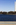 Unique portrait view from the banks of the Potomac River Tidal Basin featuring the Washington Monument towering above the capital city and the White House, National Mall, Washington DC