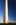 Washington Monument grounds sundown portrait view featuring American flagpoles circling the paved plaza of the national obelisk, The Mall, Washington DC