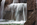 Close-up of the water crashing down the man-made waterfall inset into the red South Dakota granite walls separating the mammoth open-air rooms at the Franklin Delano Roosevelt Memorial, Tidal Basin, Washington DC