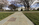 Military cemetery springtime scene featuring the marble exterior of the outdoor amphitheater and blossoming trees, Memorial Amphitheater, Arlignton National Cemetery, Virginia