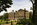 View of the dark-red brick and Jacobean facade of Kensington Palace from the Sunken Garden's Cradle Walk