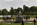 Kensington Palace grounds scene featuring the Queen Victoria Statue at the east entrance looking out on to Round Pond, Royal London, England
