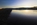A moody sunrise beachscape and coastline reflection scene from Red Wharf Bay featuring the headland at Llanddona, Area of Outstanding Natural Beauty, Isle of Anglesey, North Wales