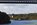 Telephoto lens view from the mainland looking along and underneath the suspended section of the Menai Suspension Bridge towards Britannia Bridge in the distance, Gwynedd, North Wales