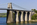 View of the Anglesey-side of the Menai Suspension Bridge including the stone arches anchoring the World Heritage Site in place, Gwynedd, North Wales
