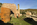 Historic scene featuring the Porth Wen Brickworks site remains including a brick chimney and old workshop, Isle of Anglesey, Gwynedd