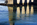 The stone arch legs of the Grade I Listed Menai Suspension Bridge reflecting off the surface of the Menai Strait, Anglesey, Gwynedd