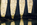 Imposing stone arch legs of the Menai Suspension Bridge reflected off the surface of the Menai Strait, Isle of Anglesey, Gwynedd 