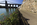 Beach Road scene featuring the Menai Strait and the historic Menai Suspension Bridge spanning the tidal water, World Heritage Site, Isle of Anglesey, North Wales