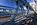 A unique Menai Bridges scene featuring the steel safety barriers, suspended cables and tower of the Menai Bridge featuring a view across the World Heritage Site and along the Menai Strait towards Britannia Bridge in the distance, Anglesey, Gwynedd