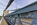 On the Menai Suspension Bridge scene featuring the suspended steel, cables, safety barriers and stone tower of the World Heritage Site, Anglesey, Gwynedd