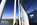 A World Heritage Site on the bridge scene featuring the suspended steel, cables, safety barriers and tower of the Menai Suspension Bridge including the Menai Strait below, Anglesey, Gwynedd