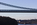 A section of the suspended steel of the Menai Suspension Bridge spanning the Menai Strait with Britannia Bridge in the distance, Anglesey, Gwynedd