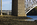 Menai Bridges scene featuring a view of a small section of both the Menai Suspension Bridge and the Britannia Bridge from the banks of the Menai Strait, Isle of Anglesey, Gwynedd
