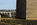 Anglesey coastline scene featuring a view of a section of the Menai Suspension Bridge from the banks of the Menai Strait