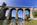 Historic bridge scene featuring a view of the imposing stone arches of the Menai Suspension Bridge, World Heritage Site, Isle of Anglesey, Gwynedd