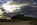 Dramatic lighthouse scene from Llanddwyn Island featuring Twr Mawr Lighthouse at the tip of the tidal island with dark cloud overhead, Newborough, Anglesey, Gwynedd