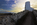 Beautiful view of Twr Mawr Lighthouse from it's stone entryway on the tip of Llanddwyn Island with Snowdonia behind