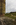Unique Llanddwyn Chapel portrait scene featuring a view of the modern Celtic Cross, Llanddwyn Bay, Newborough sand dunes and Snowdonia, Llanddwyn Island, Isle of Anglesey, Gwynedd