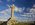 Tidal island coastal scene featuring the modern Celtic Cross on Llanddwyn Island including the Snowdonia Mountain Range as a backdrop, Newborough, Anglesey, Gwynedd