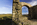 St, Dwynwen's Church ruins scene featuring a view of Llanddwyn Bay and Snowdonia in the distance, Llanddwyn Island, Newborough National Nature Reserve, Anglesey, North Wales